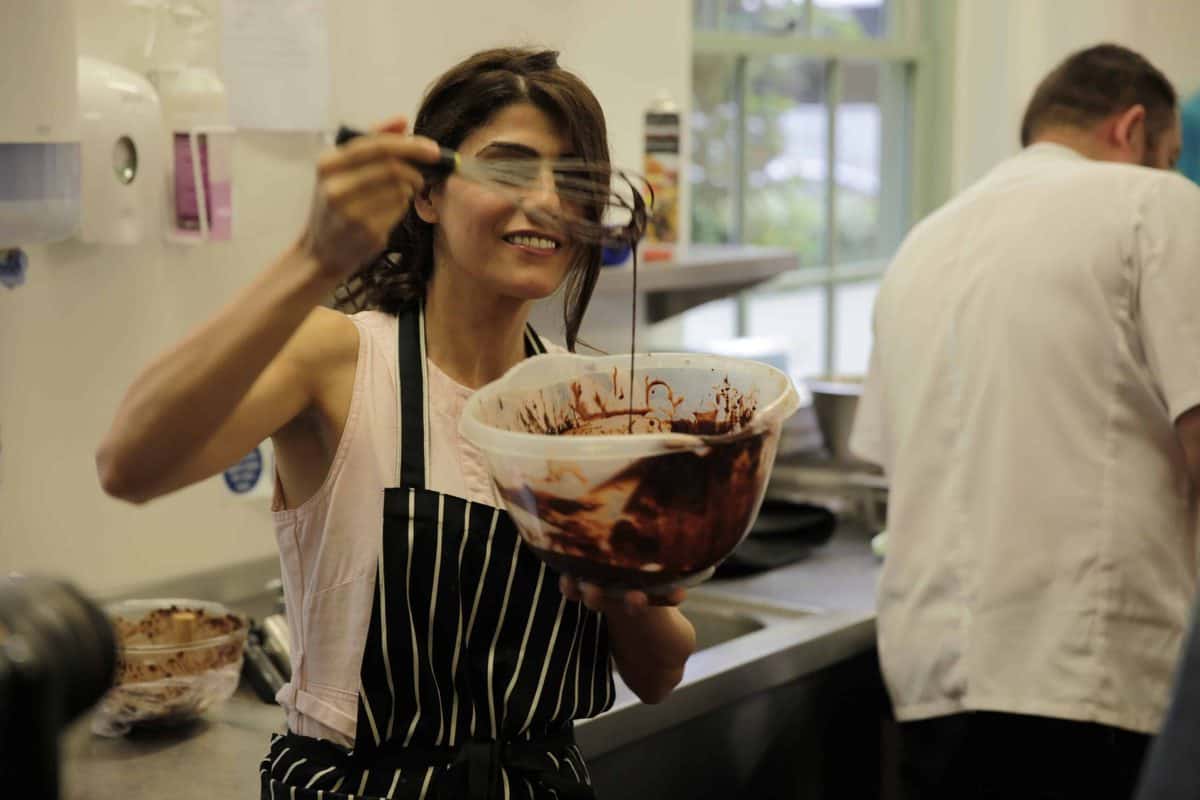 Samira from Alphafoodie making a dessert during the 25 year celebration of Duchy Organic