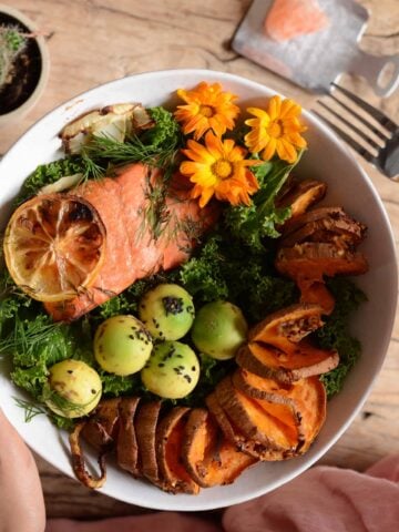 Grilled salmon with cake and baked sweet potato in a bowl