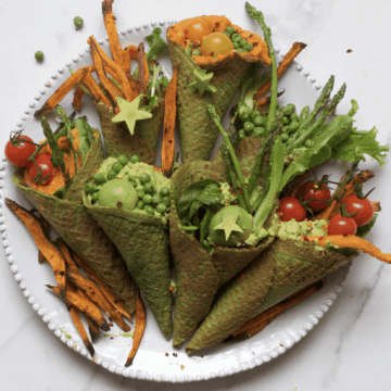 Savory kale waffle cones filled with vegetables arranged on a plate
