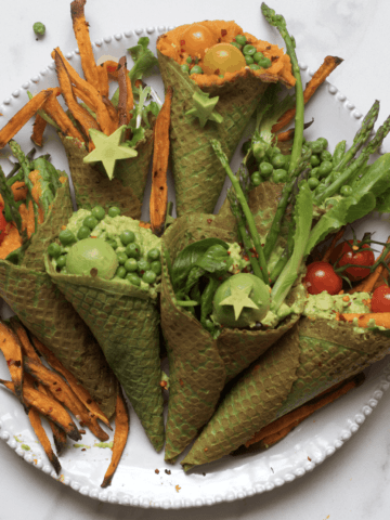 Savory kale waffle cones filled with vegetables arranged on a plate