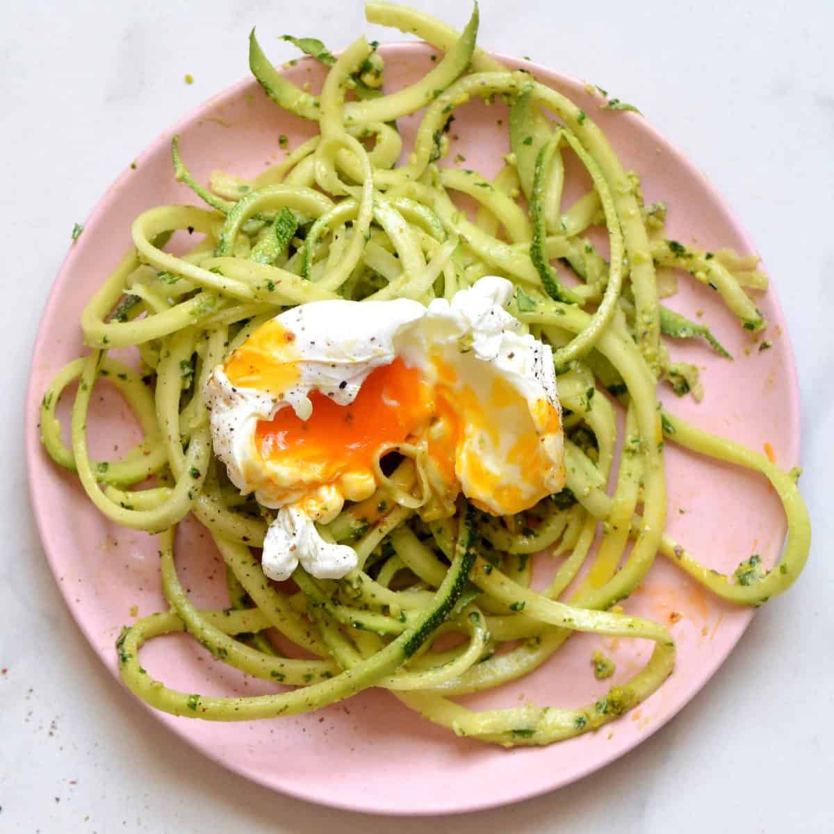 zoodles with homemade pistachio pesto and poached egg