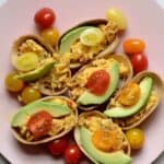 Breakfast tacos topped with avocado and cherry tomatoes
