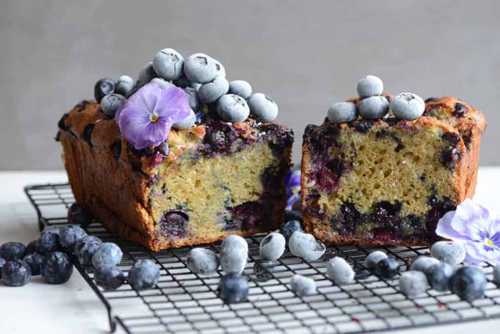 lemon blueberry loaf cake topped with frozen blueberries