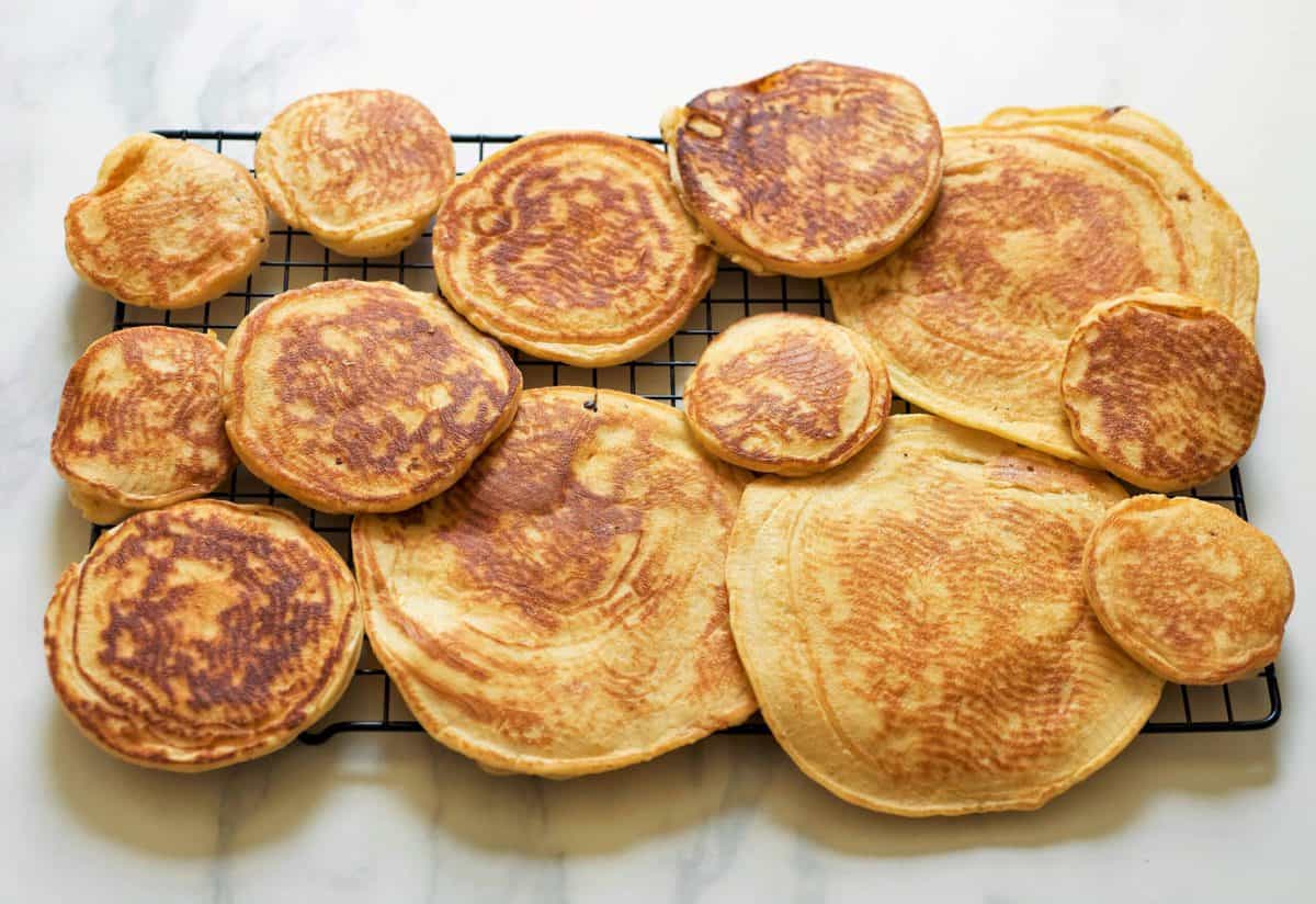 pancakes different sized on a cooling rack
