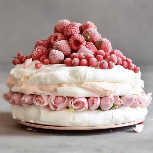 Pavlova cake topped with red berries