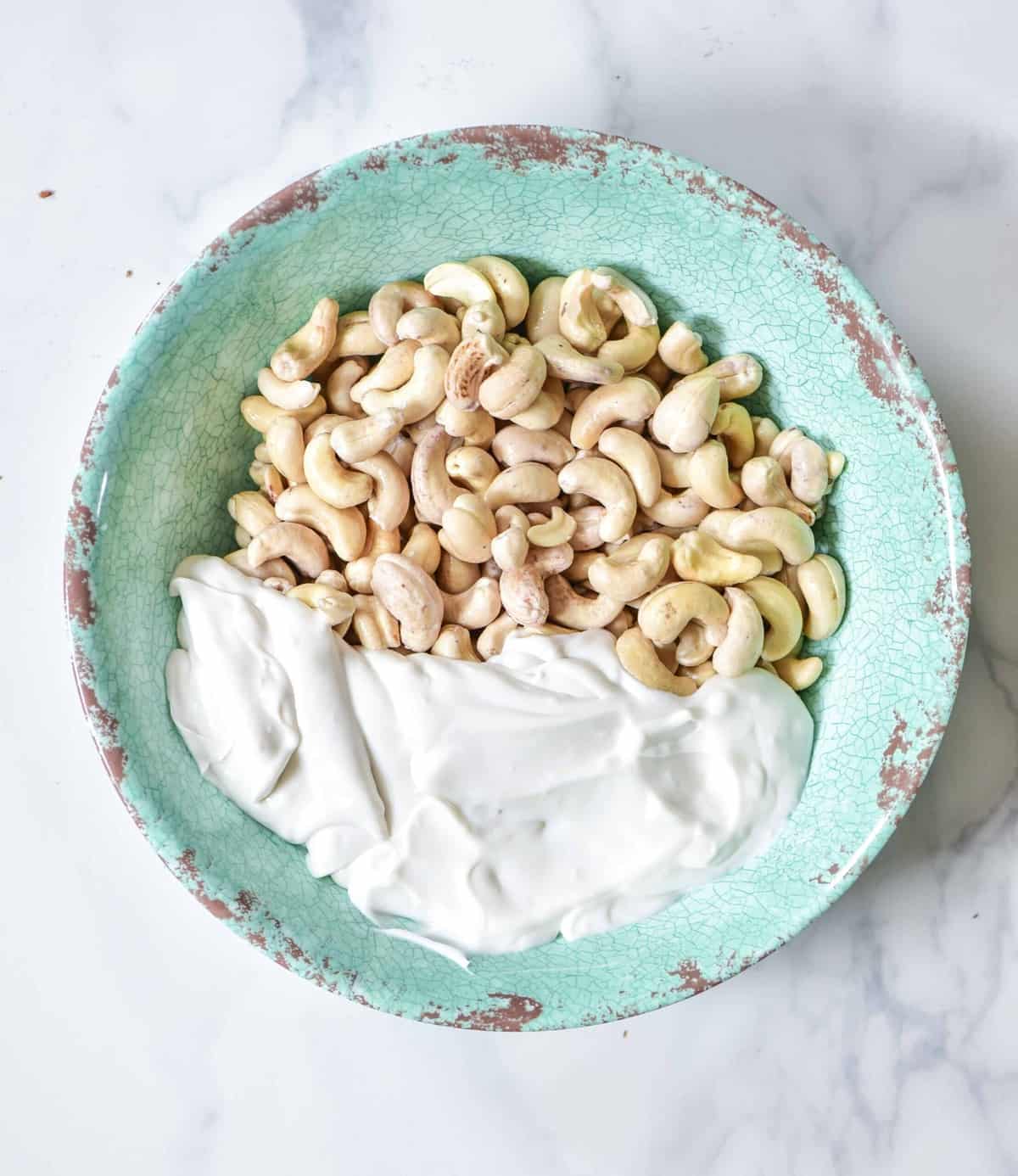 Cashews and coconut cream in a bowl