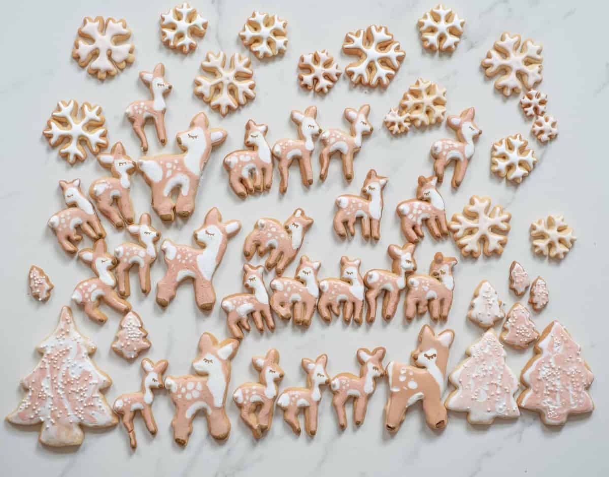 delicious decorated Christmas sugar cookie recipe. Orange sugar cookies made in fawn, snowflakes and tree shaped cookies. a yummy Christmas biscuits recipe