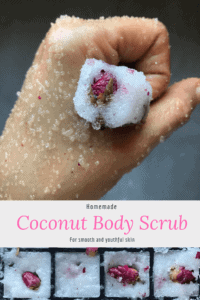 A hand holding a piece of coconut body scrub with a dried rose in it