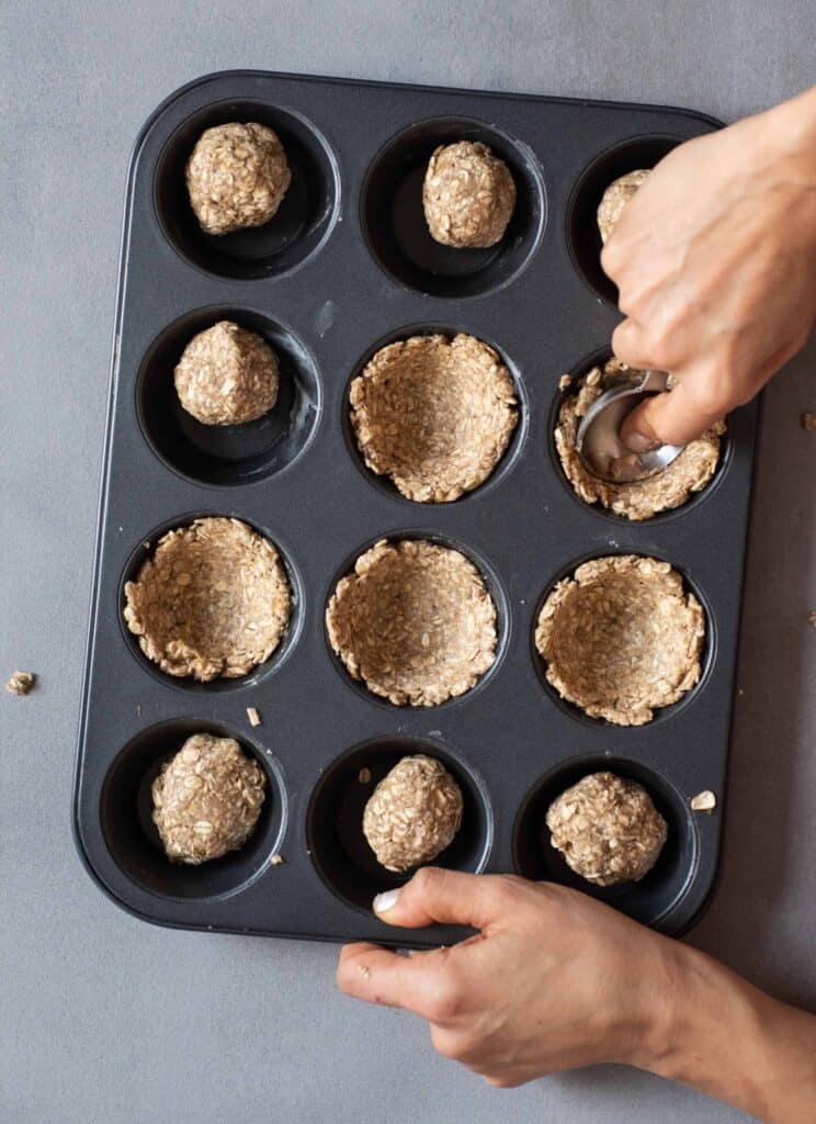 shaping granola cups in baking tray
