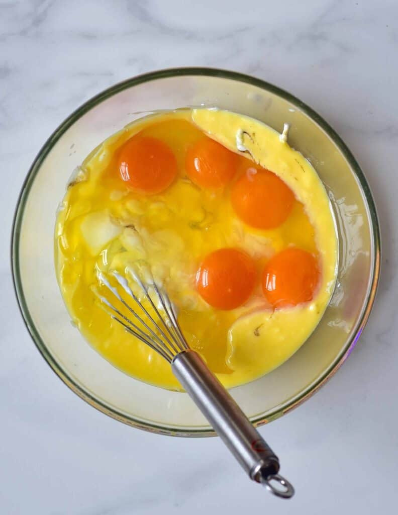 Mixing butter and eggs in a bowl