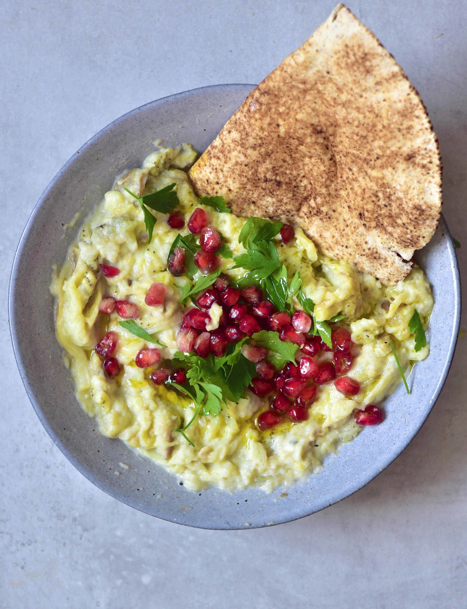 Simple Smoky Eggplant Dip ( Moutabal) in a bowl with pita bread
