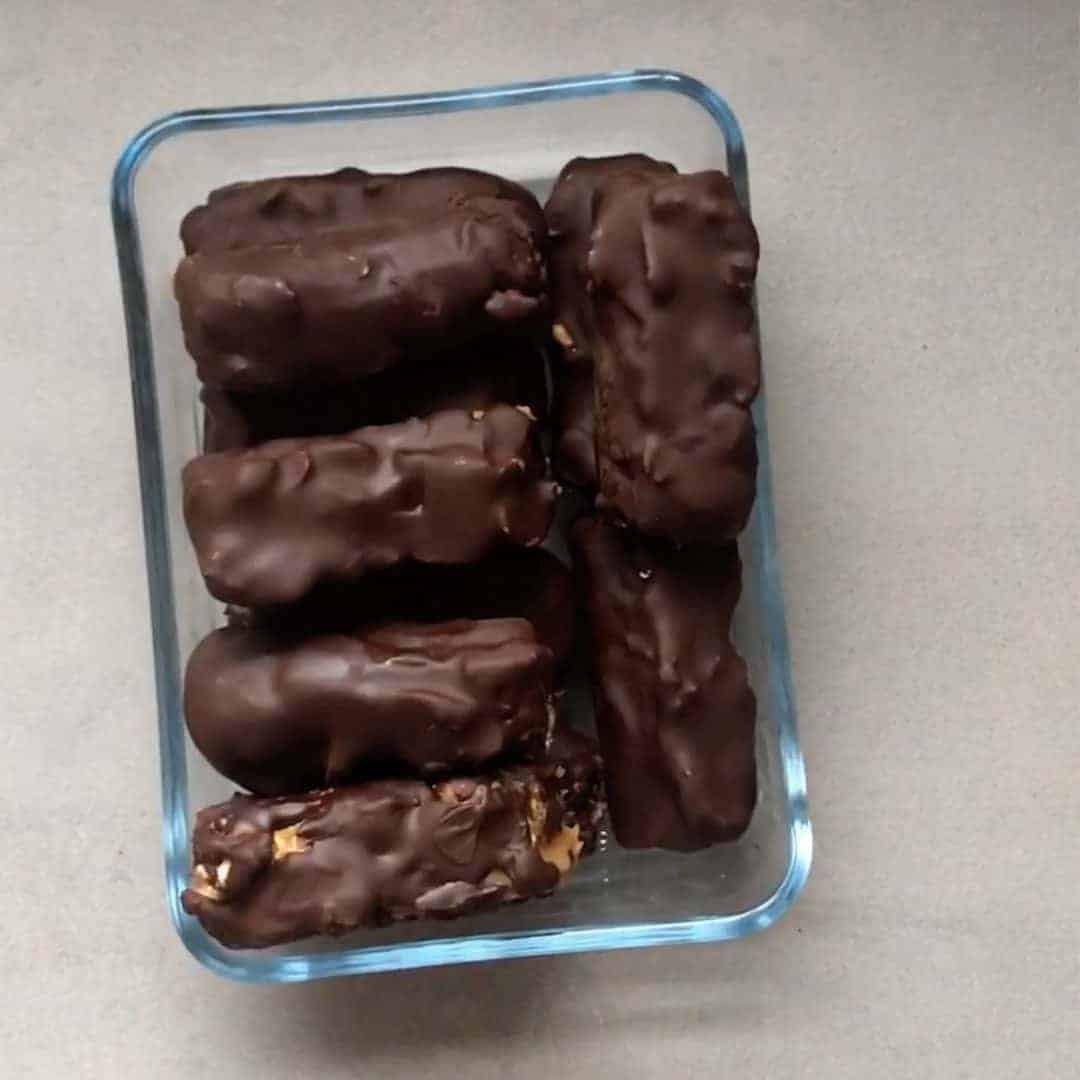 vegan homemade snickers bars in a glass container
