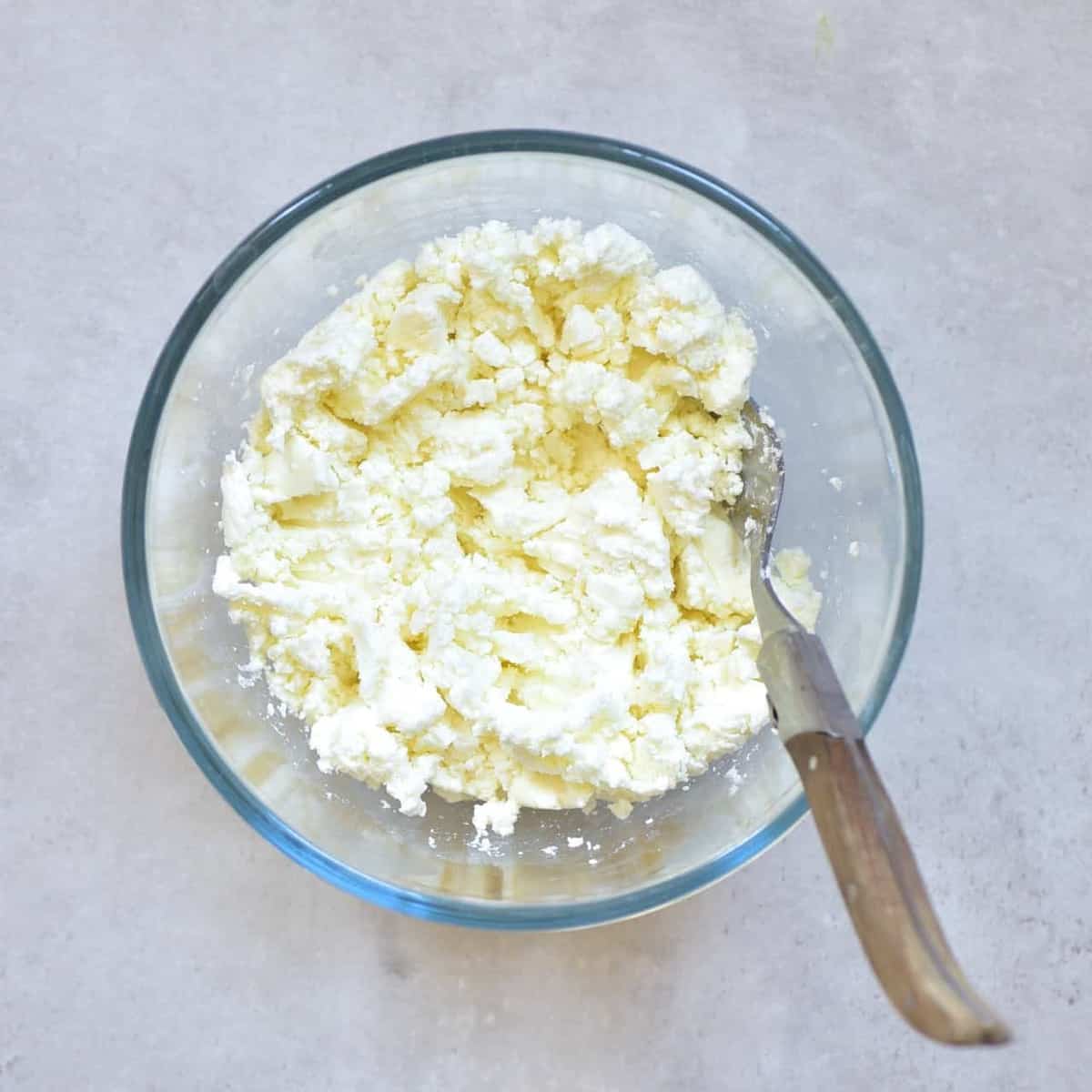 Goat cheese mashed in a bowl