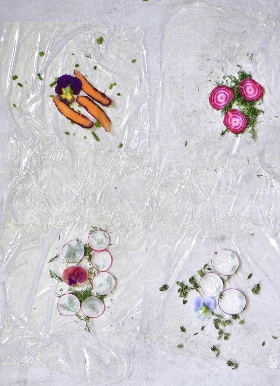 Thinly sliced veggies arranged on foil