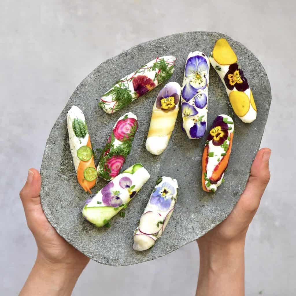 simple rainbow goat cheese rolls with edible flowers