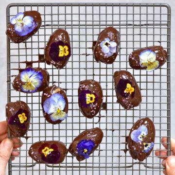 Chocolate coated dates decorated with edible flowers