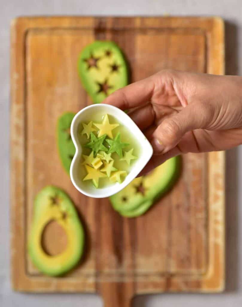 Avocado stars in a small bowl with lemon juice