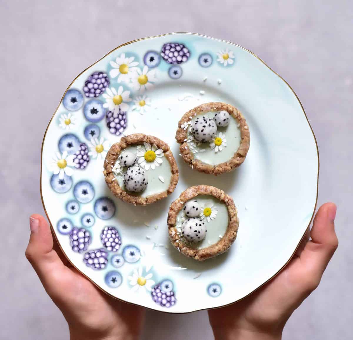 Mini green tarts with dragonfruit balls and daisy flowers