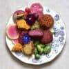 Rainbow falafel with veggies and edible flowers