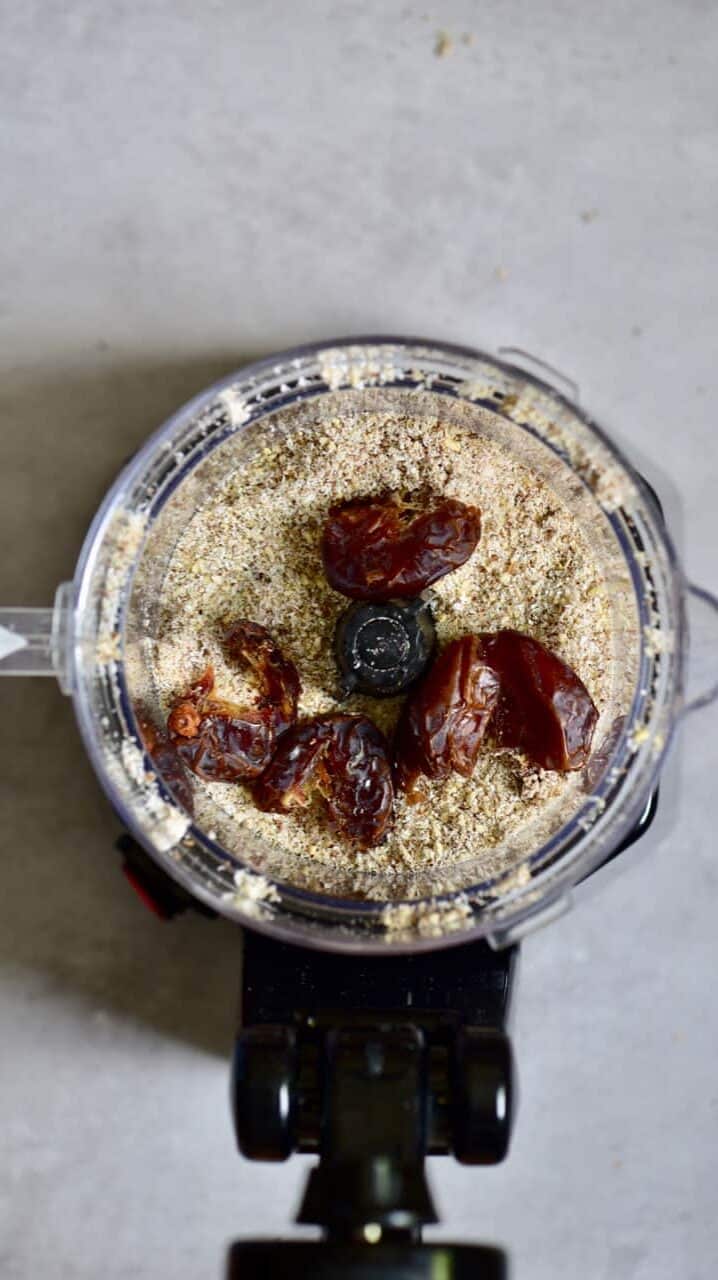 A blender jug with dates and almond meal
