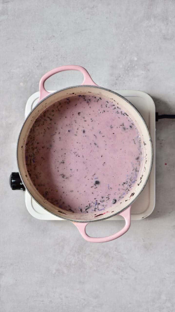 A coconut milk and blueberries mix in a pot