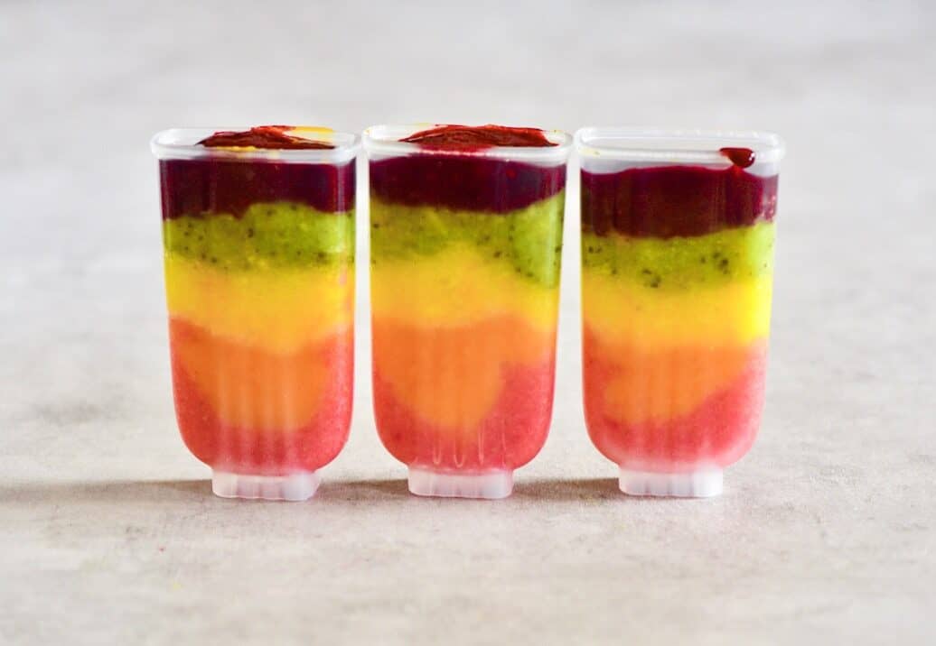 Rainbow fruit lollies mix poured in moulds