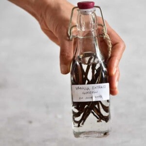 A glass bottle with vanilla pods and vodka to make vanilla extract