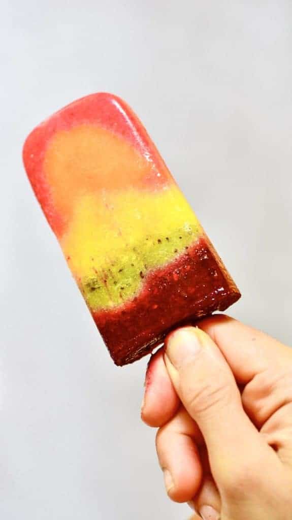 A fruit lolly held in hand