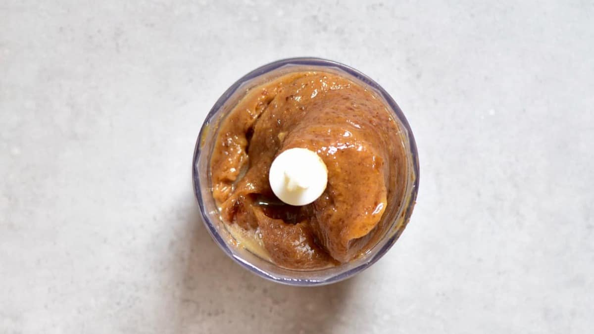 A small blender bowl with smooth caramel sauce