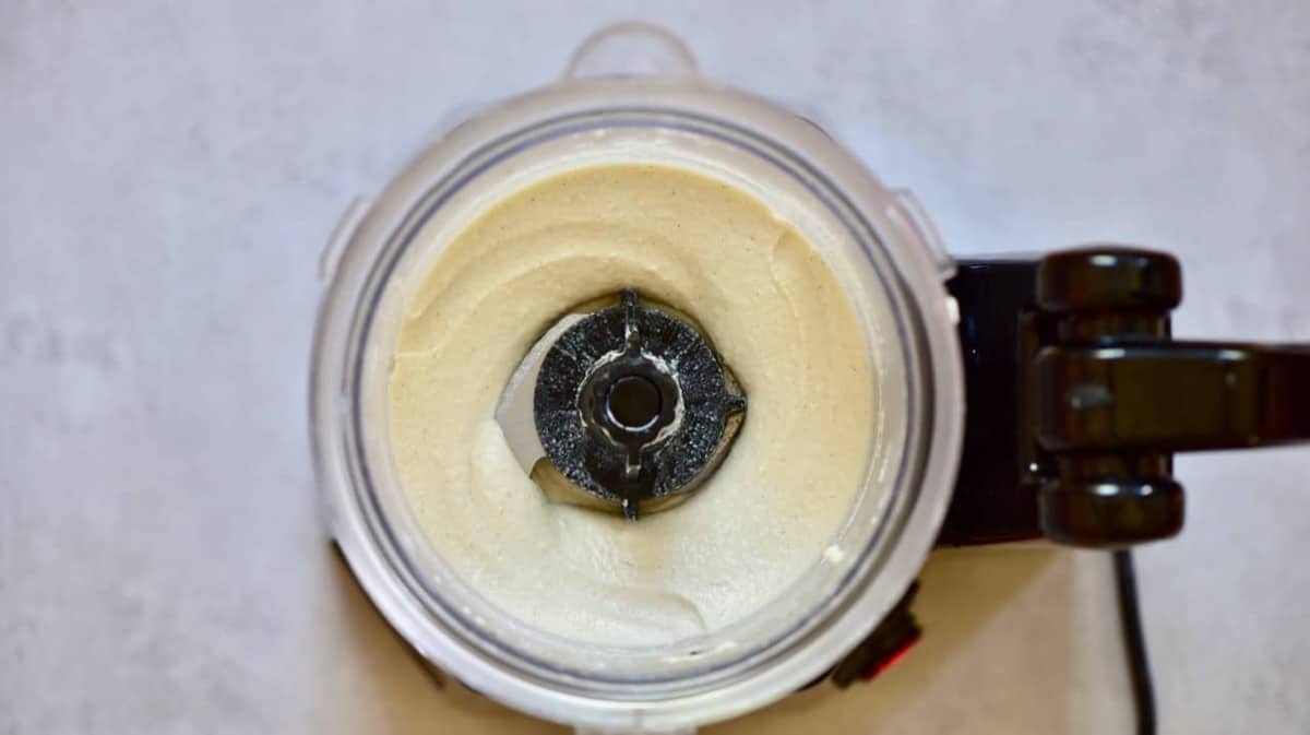 A blender filled with smoothie cashew coconut mix