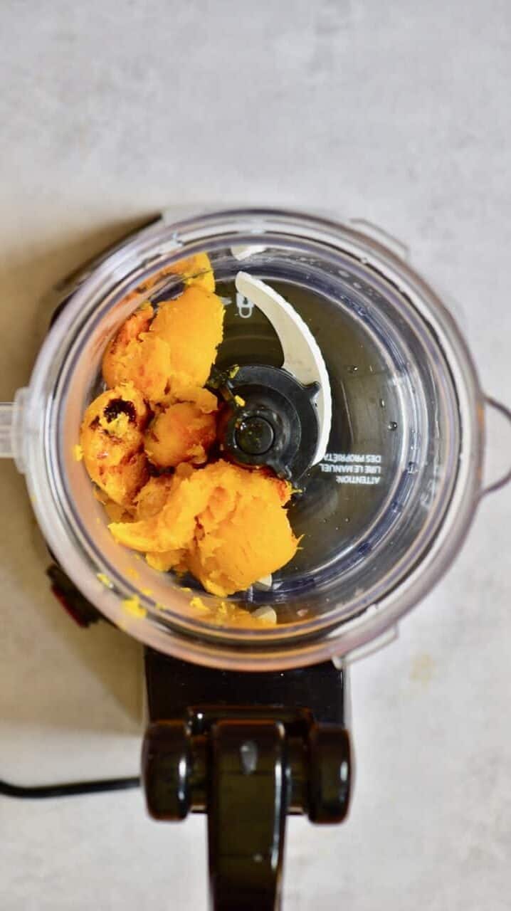 Baked pieces of squash in a blender
