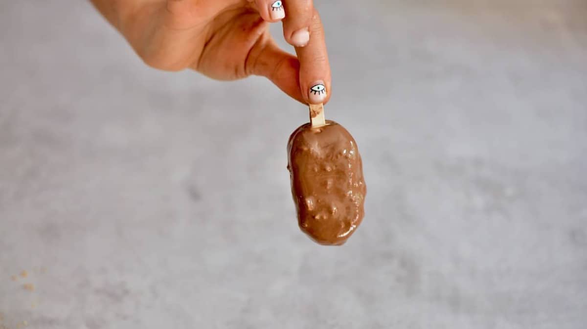 A homemade magnum ice cream with milk chocolate and peanuts coating 