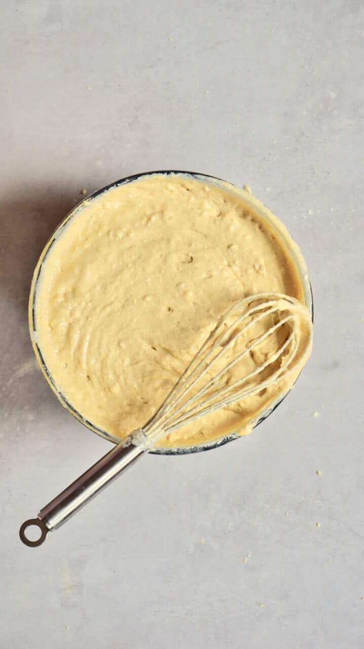 Pancake batter in a big bowl and a whisk