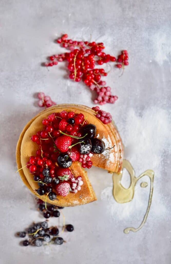 Fluffy Japanese Style Pancake Cake powdered with sugar and topped with berries