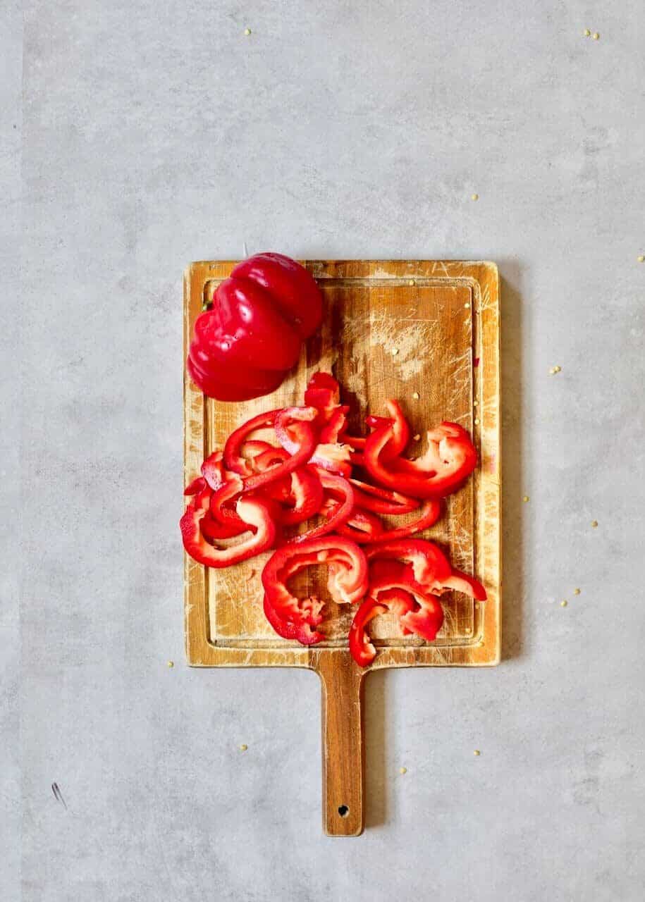 Sliced red pepper on a wooden board