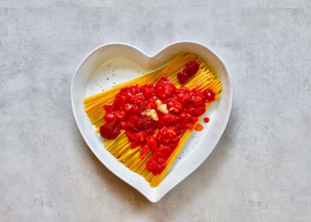 Garlic added to Linguine pasta in a heart shaped dish