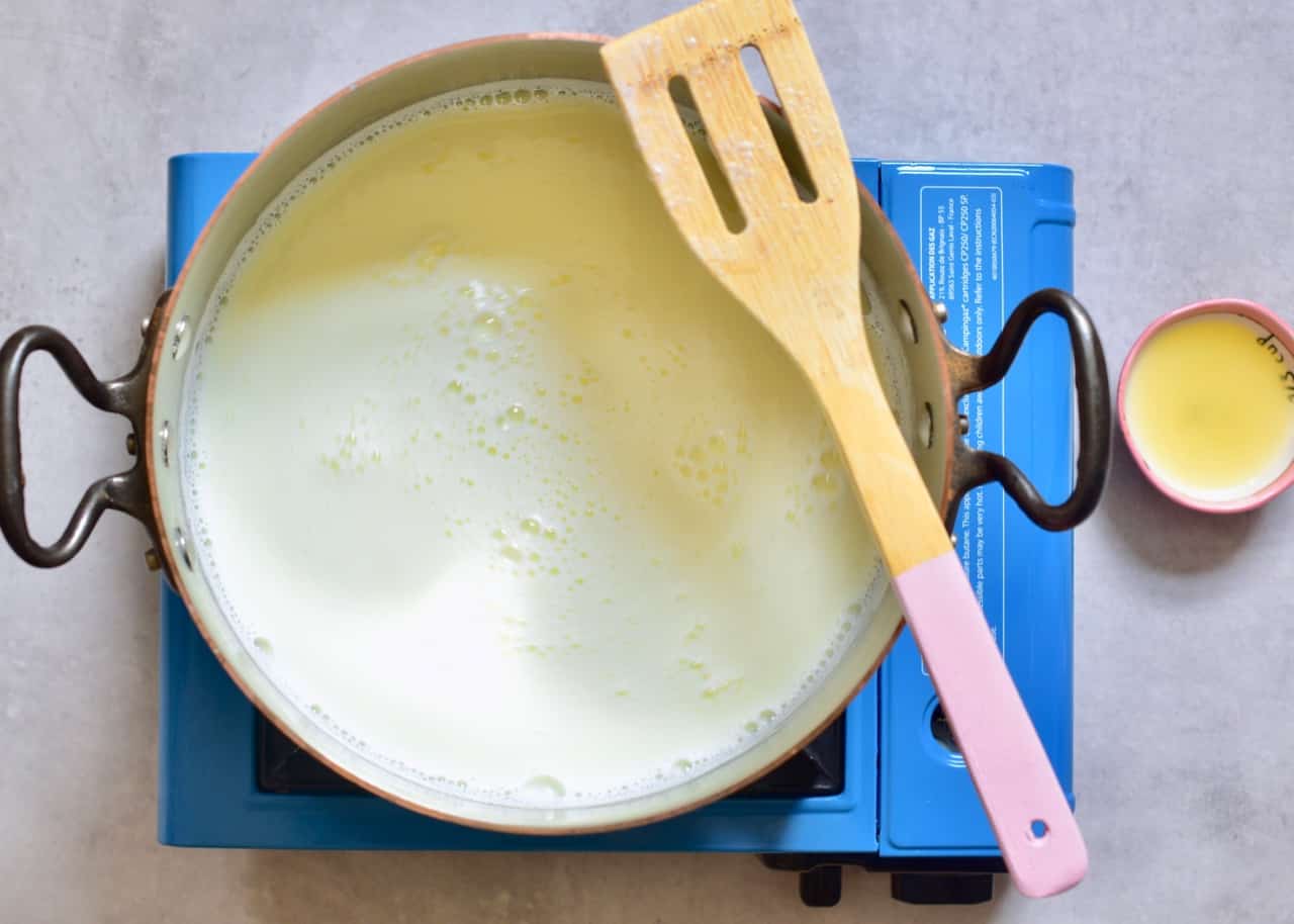 bringing milk to a boil in a pan