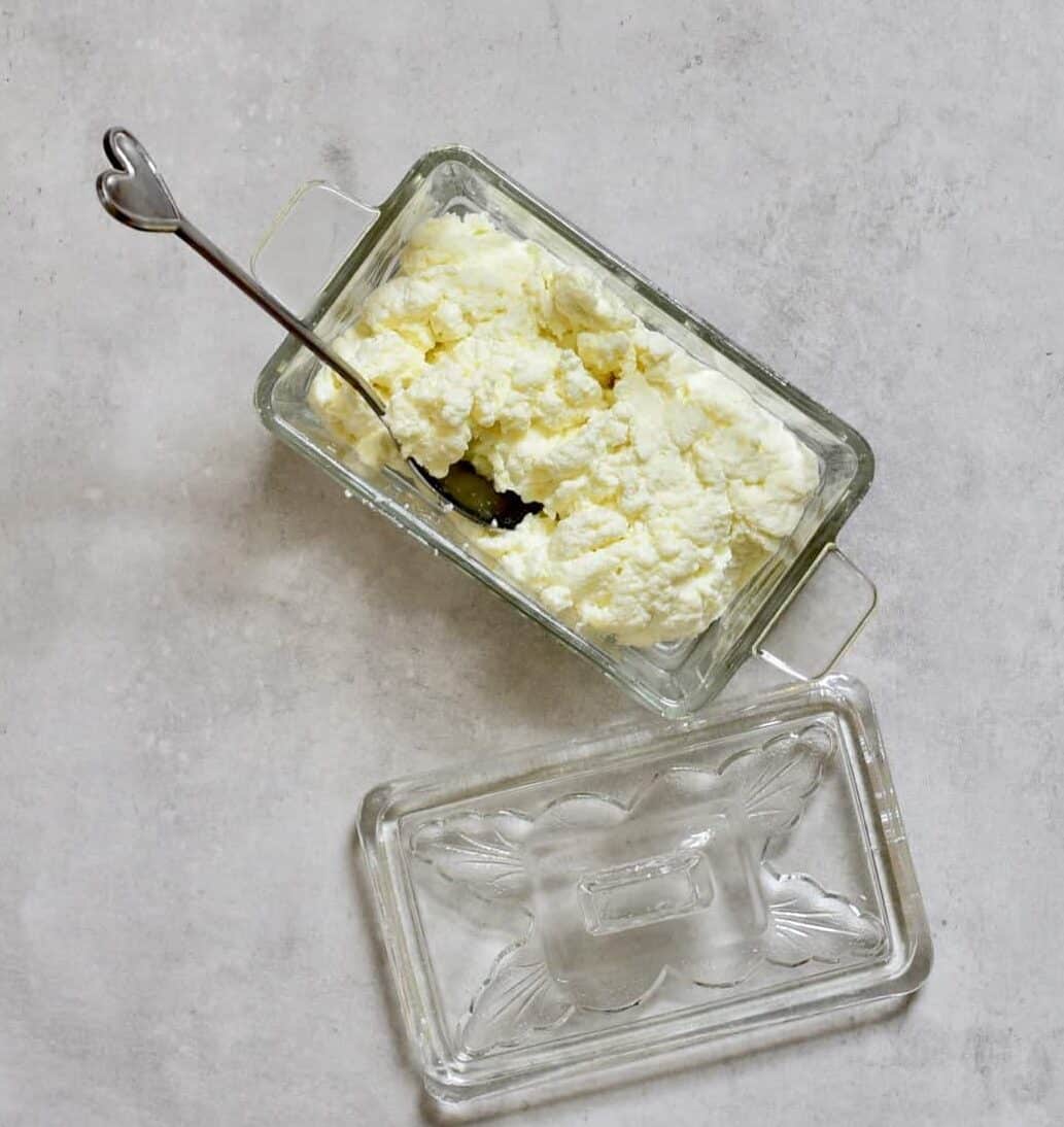 homemade ricotta cheese in a small container