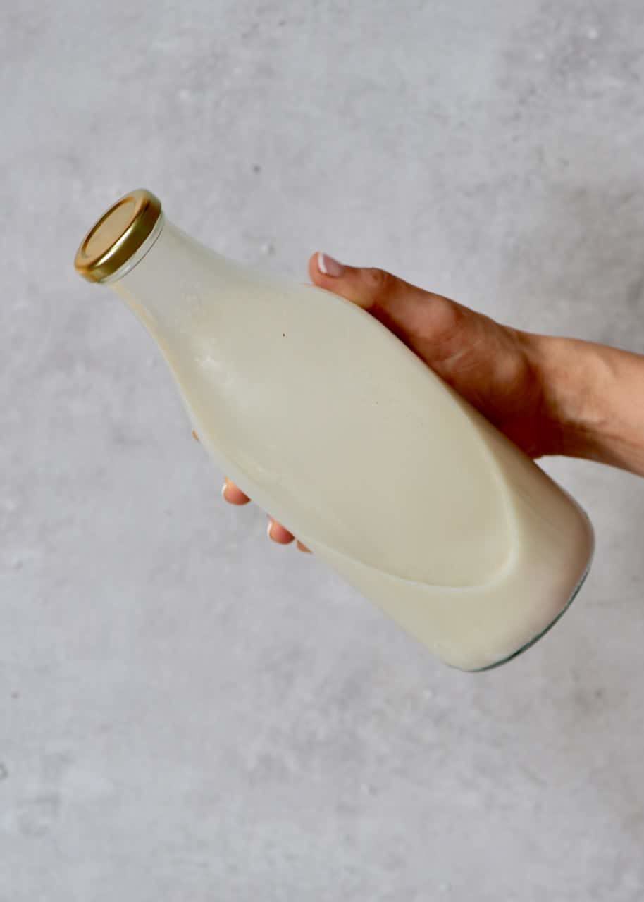 holding a coconut milk bottle