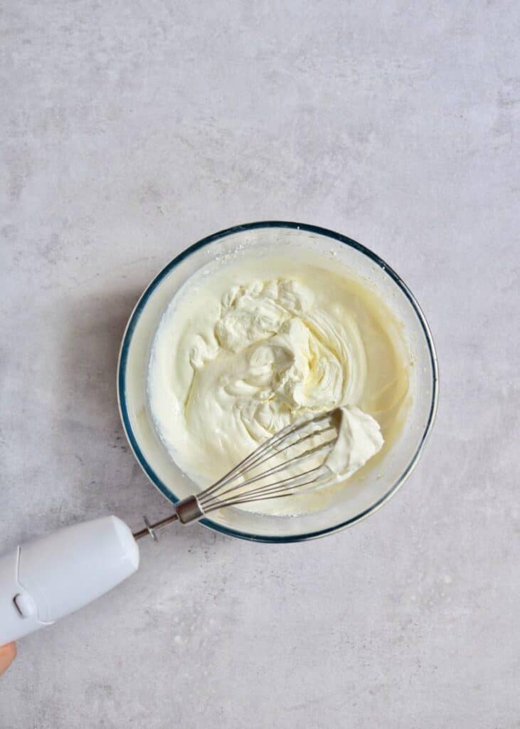 whisking frosting in a bowl