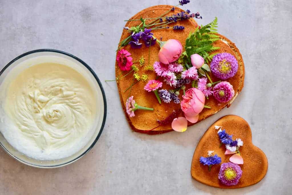 raspberry & coconut cake with homemade raspberry jam and whipped coconut cream. A delightful, simple celebration cake. Decorated with edible flowers. raspberry & coconut cake with homemade raspberry jam and whipped coconut cream. A delightful, simple celebration cake. Decorated with edible flowers.