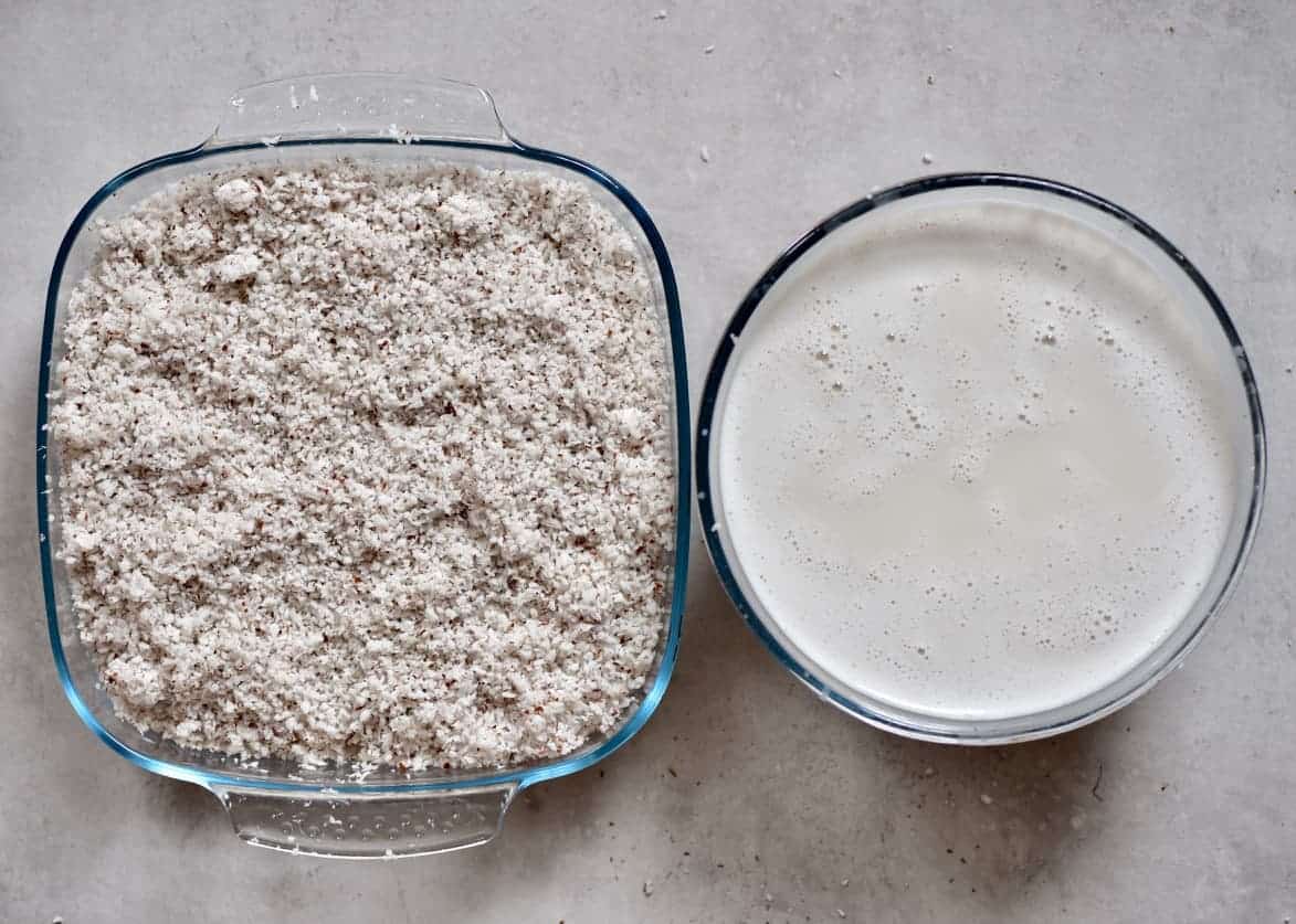 Coconut milk in a bowl and leftover coconut meal in a square container 
