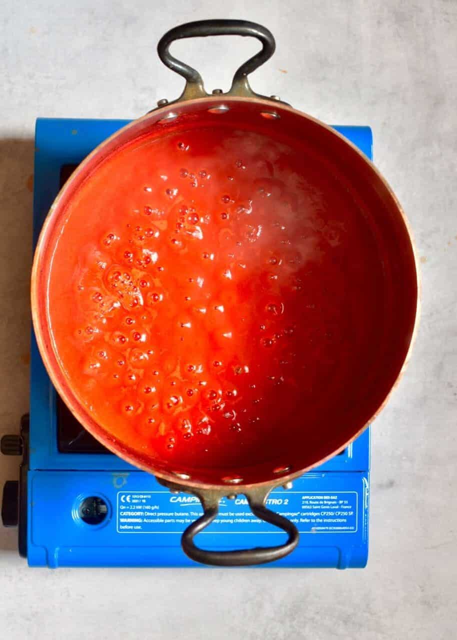 Reducing tomato juice in a pot