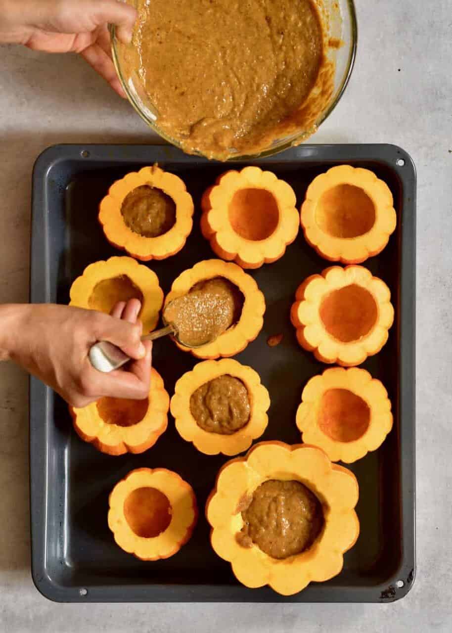 Filling mini pumpkins with cake batter