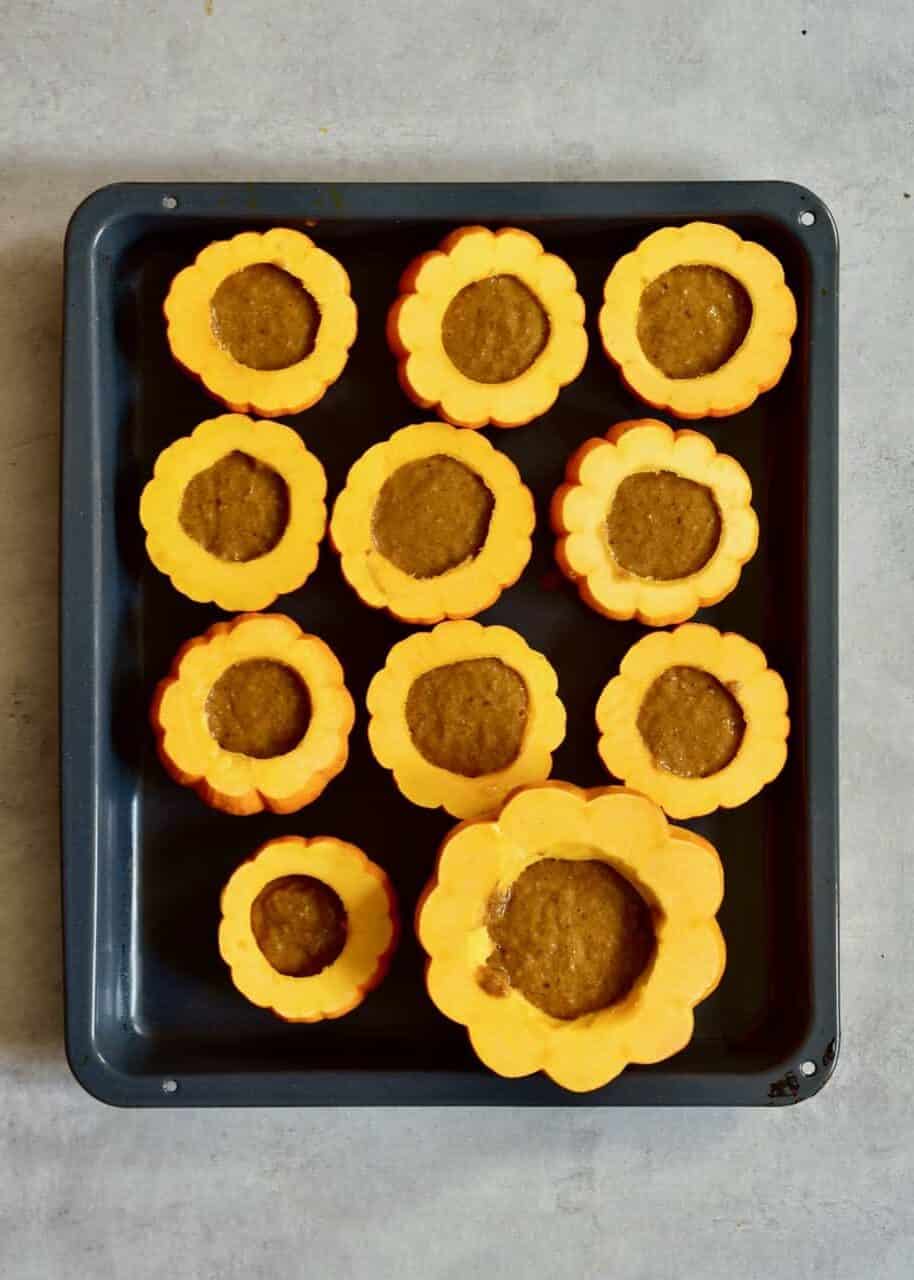 mini pumpkin cakes on a tray ready to bake