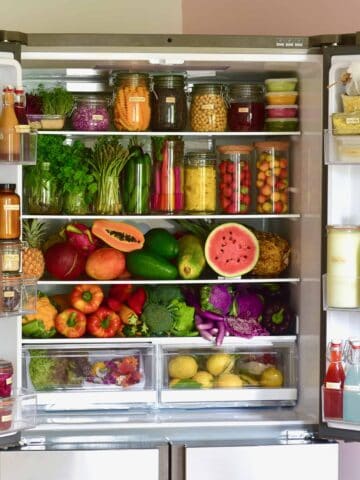 A refrigerator filled with fresh fruit and vegetables and other food