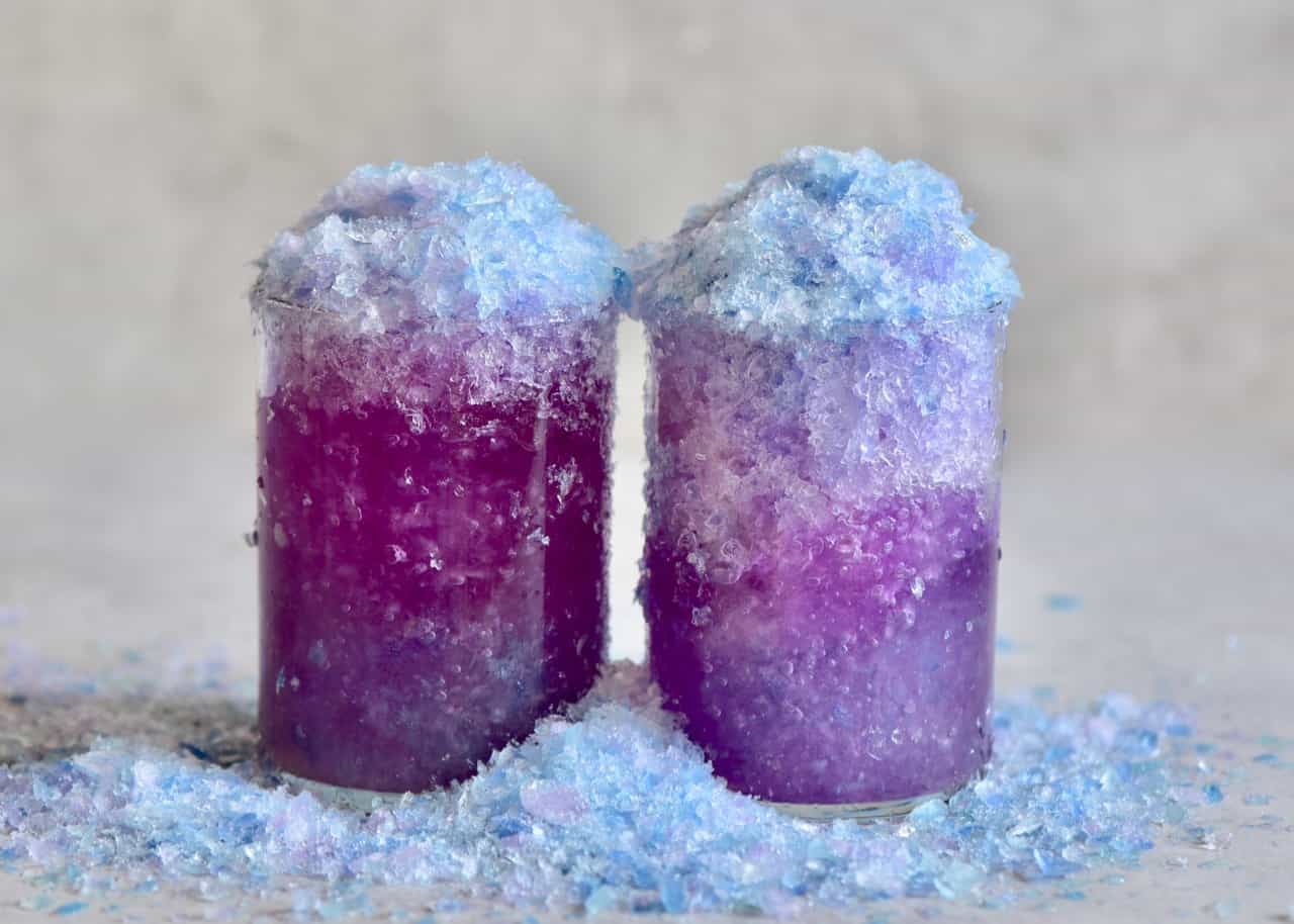two purple magic lemonade glasses next to each other
