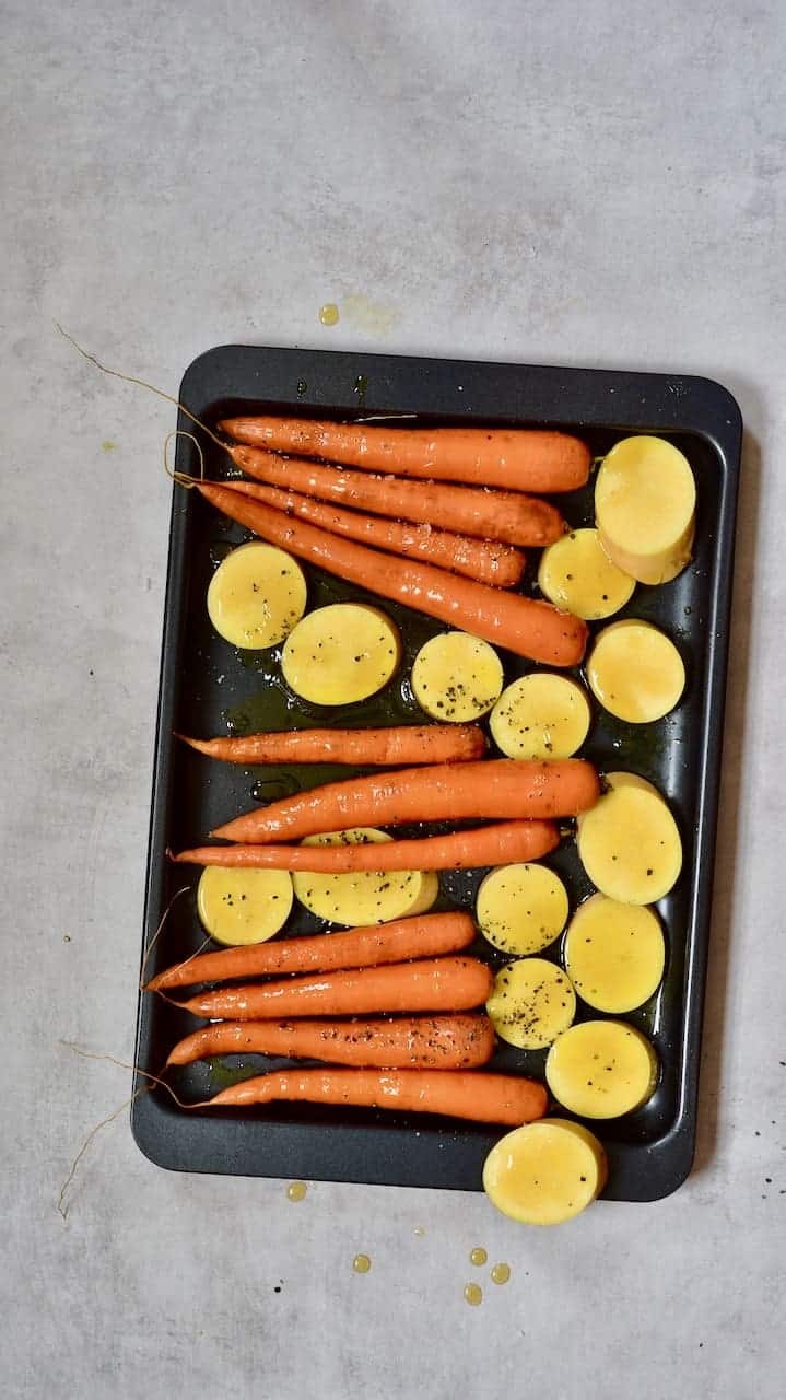 carrots and squash on baking sheet and drizzled with oil