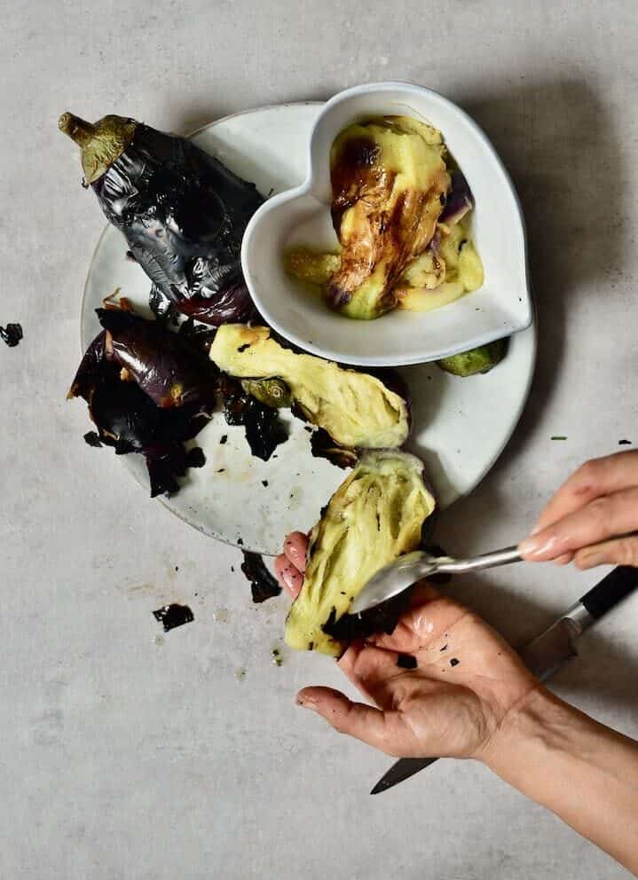 scooping out the flesh of aubergine / eggplant