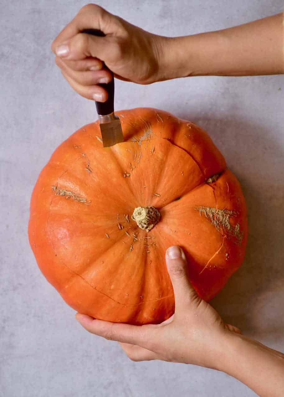 Cutting into a pumpkin